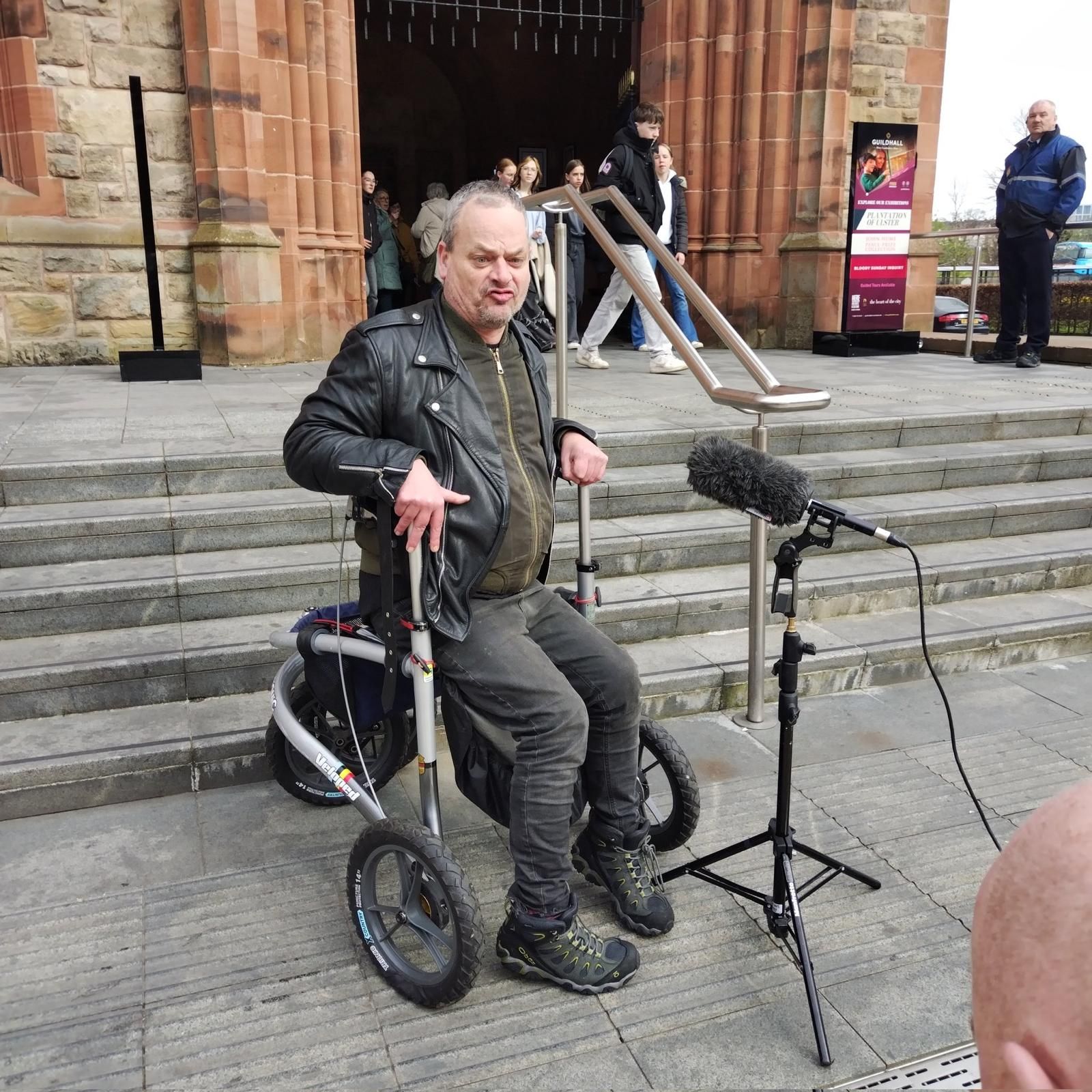 Tony O'Reilly outside Guildhall Derry, speaking into mic
